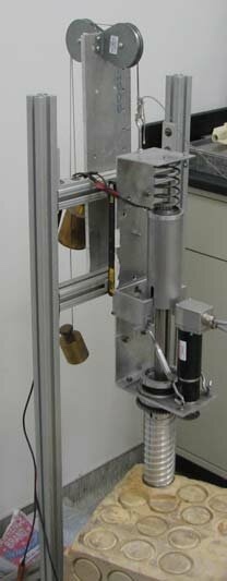 Assembled Auto-Gopher laboratory prototype mounted vertically on an aluminum test frame